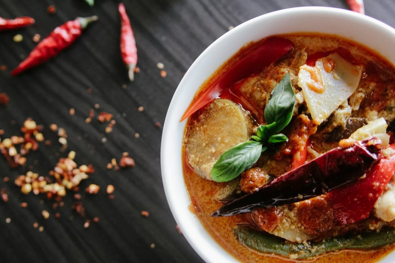 Bowl of soup with spoon on table