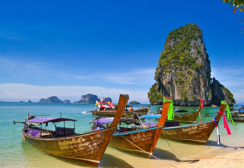 Beach with parked boats and rock formation