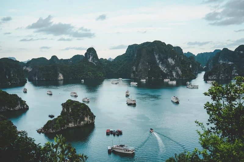 Blue bay with rocky island and boats