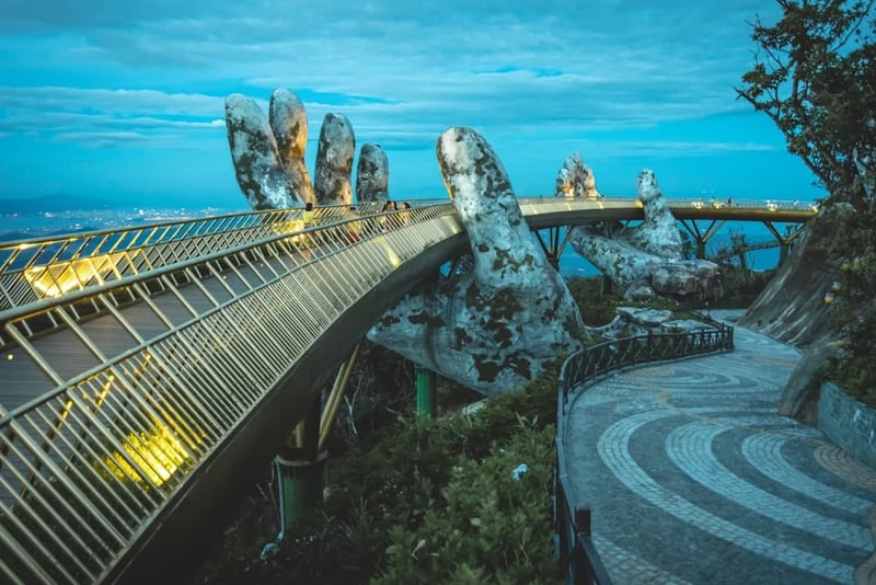 Bridge with metal walkway and sculptures of hands